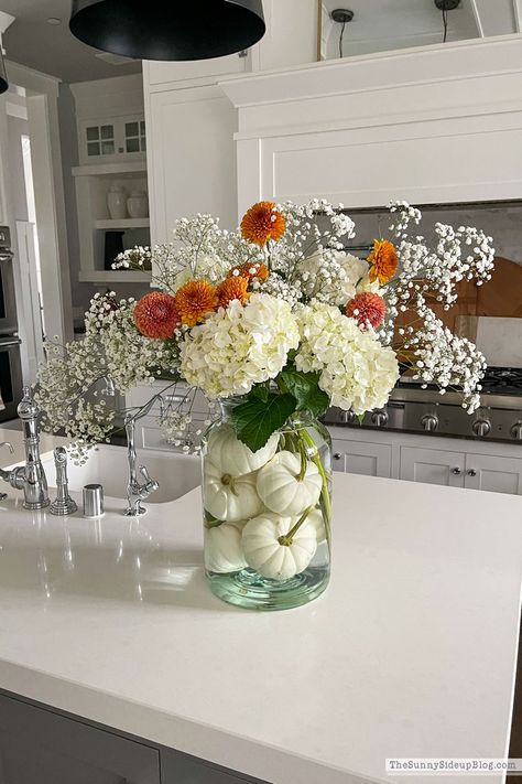 Pumpkin Flower Arrangement (Sunny Side Up) Pumpkins In Glass Vase, Pumpkin And Floral Centerpieces, Pumpkin Floral Arrangements Wedding, Fall Wedding Pumpkin Decor, Pumpkins In Vase Centerpiece, White Pumpkin Table Centerpiece, Flower Pumpkin Centerpiece, Flower Arrangements With Pumpkins, Fall Flower Display