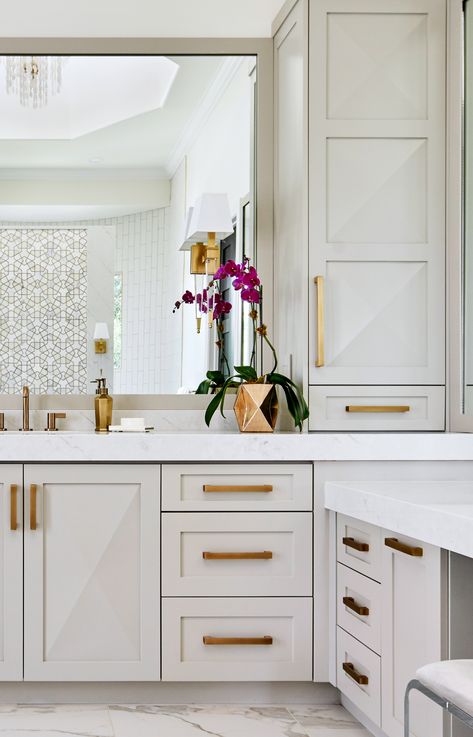 Soft taupe custom cabinets with antique gold hardware grace this luxurious master bath by Haven Design & Construction. The raised cabinet design on the doors echoes the marble and mosaic tile across the bathroom. This bathroom also features a freestanding tub, a shell chandelier in the 22' high cupola, a striking gold and marble mosaic accent wall behind the tub and a curved walk in shower. Luxurious Master Bath, Fossil Creek, Gold Bad, Best Kitchen Design, Wall Cabinets, Master Bath Remodel, Casa Exterior, Home Luxury, Gold Bathroom