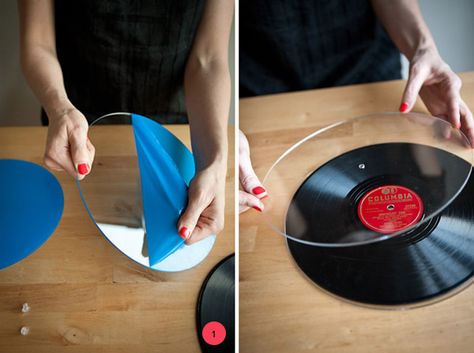 So awesome!   Items Needed:Records! (you can use 12″/10″/7″)Two pieces of clear plexiglass acrylic (cut to size, with a hole drilled directly in the middle)A sturdy base with a flat top (I used thrifted candlesticks)Clear screw fastener (I used 3/8 in. and cut them down a little for a perfect fit)A strong glue   Step One: Take the plastic off your freshly cut acrylic, and place one piece on each side of your record to make sure it fits. You’l... Record Garland Diy, Record Plates, Record Cake Stand, Records Crafts, Cake Plates Diy, Soul Train Party, Record Cake, Diy Record, Vinyl Record Crafts