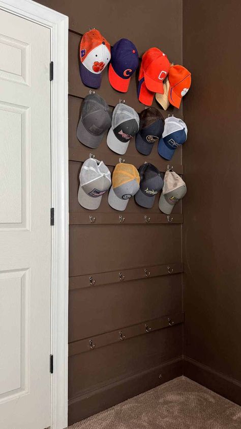 Baseball Hat Wall Organizer Baseball Hat Display Ideas Wall Bedroom, Hat Rack In Closet, Hat And Purse Wall Display, Ball Cap Holder Ideas, Storing Baseball Caps, Baseball Cap Organization Ideas, Ways To Hang Hats On Wall, Baseball Hat Decorating Ideas, Hat Organizer Ideas