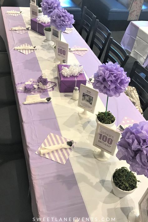 Tissue paper pom-pom flowers are great for a spring table.  Easy to make and inexpensive.  Lavender purple table.  #purple #springdecor SweetLaneEvents.com Purple Flower Party Decorations, Decoration For Table Party, Lavender And White Table Setting, Lavender Color Centerpieces, Purple And White Table Decorations, Lavender And White Party Decorations, Purple Table Cloth Ideas, Purple Table Arrangements, Tissue Pom Pom Centerpieces