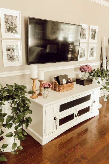 Don't have a large, expensive TV entertainment center? Try this budget-friendly method instead to decorate around your TV. In just four easy steps, you'll have a beautifully decorated TV wall. Subscribe to my blog A Brick Home for more DIY & decorating projects like this! STEP 1: BUY/PAINT A TV CONSOLEWe bought our TV console on Facebook Marketplace for just $35! It was in great shape but needed some TLC, so I painted it white. If you already have a TV console but it is outdated, a f�… How To Decorate Around A Tv, Tv Console Decor, Tv Stand Decor Ideas, Decor Around Tv, Decoration Buffet, Fun Room, Tv Stand Decor, Living Room Tv Stand, Tv Decor