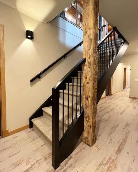 🏡✨ Transforming rustic elegance into a reality! This custom railing, beautifully divided by a rustic post, adds a unique touch to this cozy log home basement. Perfect blend of craftsmanship and charm. 🔨 Home reno by the talented team at @rochellelynnedesign #contemprarail #stairdesign #staircasedesign #stairs #railings #yycstairs #yycrailings #customrailing #rusticcharm #homedesigns Railing To Basement, Industrial Staircase Railing, Industrial Railings For Stairs, Exposed Staircase To Basement, Reclaimed Wood Stair Railing, Rustic Industrial Stair Railing, Open Basement Stairs, Custom Railing, Basement Stairs