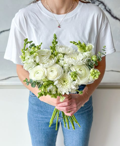 A crisp white breeze of cloud-like chrysanthemums, petal-packed ranunculus and white-hot snapdragons! Important deets: Some ranunculus will arrive budded as they are fresh from the grower but will open beautifully and can be enjoyed for longer! The exact varieties and colour may vary slightly (because, nature!) but your blooms will be beautiful and fresh - guaranteed! White Ranunculus Arrangement, Snapdragon Flowers Wedding, White Rose And Ranunculus Bouquet, Ranunculus And Rose Bouquet, Ranunculus Bouquet White, Ranunculus Bouquet Wedding, Foxglove Wedding, White Ranunculus Bouquet, Snapdragon Bouquet