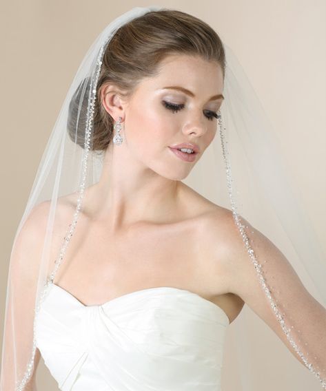 Complement a beaded gown with the perfect veil. An intricately beaded edge of silver beads, clear sequins, and tiny pearls shimmers gracefully on this single tier design. Beautifully enhance your wedding photos with subtle sparkle. Wedding Veil With Pearls, Fingertip Length Wedding Veil, Beaded Edge Veil, Veil With Pearls, Cathedral Length Wedding Veil, Fingertip Length Veil, Beaded Wedding Veils, Fingertip Wedding Veils, Ivory Bridal Veil