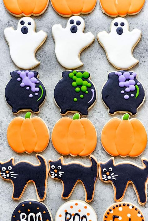 These cut-out Halloween Sugar Cookies are soft and delicious but still hold their shape after baking. Decorate them with my super popular easy royal icing using the easiest techniques ever to scare up some Halloween fun! #sugarcookies #cookies #Halloween #royalicing #decorating #easy #best #soft #homemade Halloween Cookies Decorated Recipe, Cookies Halloween Easy, Halloween Cookies Cut Out, Halloween Flood Icing Cookies, Halloween Biscuits Decorated Cookies, Wilton Halloween Cookies, Halloween Cutout Cookies Decorated, Cookie Decorating Icing Ideas, Decorated Cut Out Cookies