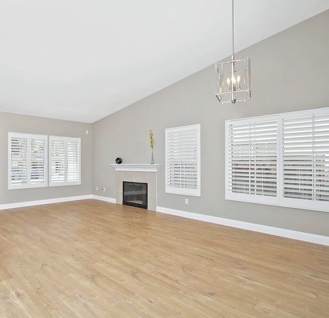 🏡🛠 Perfect neutral gray walls, light oak floors, and that gorgeous industrial cage pendant light 😍 • • • 💻www.BuyInvestSell.com… Oak Floor Grey Walls, Light Wood Floors With Gray Walls, Flooring With Light Gray Walls, Wood Floors Gray Walls, Living Room With Oak Floors, Light Oak Wood Floors, Oak Floor Living Room, Grey Walls White Trim, Light Oak Floors