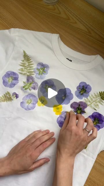 Custom WearHouse on Instagram: "Flower-printed tee 🌸💐 by @hammerflower  . This botanical printing method is achieved by hammering flowers into the fabric! ✨️ What do you think of this technique? . . . . #botanicalart #botanicalprint #flowerpressing #flowerprint #floralprint #floralfashion #floralart #naturaldye #customtees #handprintedtextiles #textileart #tshirtprinting" Flower Hammer Art On Fabric, Flower Hammering On Fabric, Flower Printing With Hammer, Tshirt Flowers Print, Pressed Flowers On Fabric, Hammer Flowers On Fabric, Hammering Flowers On Fabric, Hammered Flowers On Fabric, Botanical Printing On Fabric