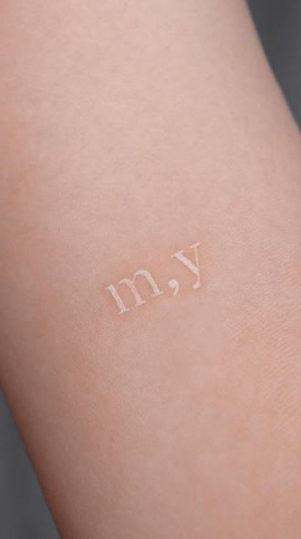 Minimal Tattoo On Wrist, White Ink Letter Tattoo, White Ink Minimalist Tattoo, Clear Ink Tattoo, White Ink Heart Tattoo, Moon Tattoo White Ink, White Letter Tattoo, Simple White Tattoos, Tiny White Tattoos