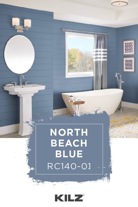 For a classic shade of blue with a light gray undertone, turn to KILZ COMPLETE COATⓇ Paint & Primer In One in North Beach Blue. Featured in this nautical bathroom, this medium-tone blue pairs beautifully with the bright white trim and subtle pops of yellow accent colors. Click below for full color details to learn more. Two Tone Blue Bathroom, Beach Blue Paint Colors, Beach House Colors Interior Walls, Nocturne Shade, Behr Blue Paint Colors, Pot Herb Garden, Painted Pot, Nautical Bathroom, Blue Paint Colors