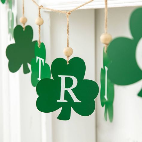 Buy Glitzhome® St. Patrick's Metal Shamrocks Garland at Michaels. com. A festive piece that makes a perfect addition to your St. Patrick's Day holiday decorative theme. This rustic accent is the perfect decorative piece to enhance your St. Patrick's Day themed décor. Eleven metal shamrocks on jute string allows for easy hanging from your fireplace or other areas inside or outside your home. Details: St. Patrick's Metal Shamrocks Garland design 6 ft. 0.79 lb. Made of 90% iron, 5% solid wood, and Shamrock Garland, Festive Look, Host Gifts, Luxe Gifts, St Patrick’s Day, Hanging Decor, St Patrick, St Patricks Day, Decorative Pieces