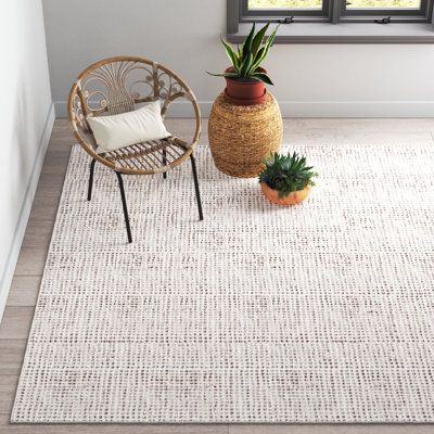 This rectangular hand tufted area rug adds a textural foundation to your space. Made of a wood/cotton blend, it features a nubby weave in brown and ivory. The very low pile height of 0.02” makes it a stable wall covering for your furnishings - and also does not bunch up when you open or close the door. Envision this area rug in your beach house or in a casual space such as a den or family room. The neutral color is a match for most design schemes. We recommend the use of a pad to prevent slippag Area Rugs In White Living Room, Area Rug For White Couch, Large Neutral Rug Living Room, Beige Area Rugs In Living Room, Japandi Area Rug, Wool Area Rugs In Living Room, Playroom Area Rug, Organic Modern Rug Living Room, Organic Modern Living Room Rug