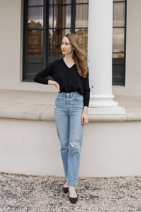 A girl wearing a black knit top and Levi's ribcage straight ankle jeans, minimalist fashion ideas, minimalist outfits, capsule wardrobe inspiration. Levi Ribcage Straight Ankle Outfit, Levi’s Ribcage Straight Ankle Outfit, Levi’s Ribcage Straight Ankle Jeans Outfit, Levi’s Ribcage Straight Ankle, Levi’s Ribcage Jeans, Levi’s Ribcage Outfit, Levis Ribcage Straight Ankle Jeans Outfit, Straight Ankle Jeans Outfit, Levis Ribcage Jeans Outfit