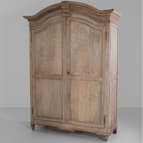 The arched antique carved French wardrobe was crafted in France, circa 1820. Hand-carved border trim accents bring this 2-door wardrobe cabinet to life. A bleached finish on the oak construction enhances its beauty. This eye-catching piece is perfect for your bedroom. #french, #antique, #armoire Antique French Bedroom, French Country Armoire, Wooden Armoire, Creating A Capsule Wardrobe, Armoire Makeover, Vintage Armoire, Elegant Outdoor Furniture, Mirrored Armoire, Antique Wardrobe