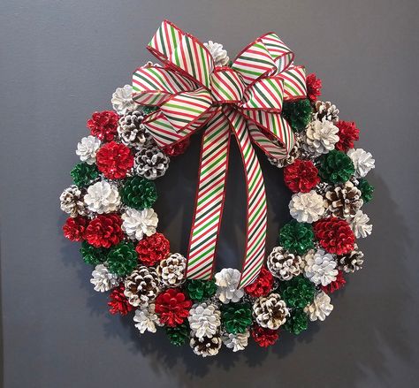 Holiday Sparkling Pinecone Wreath/ Hand Made Pinecone Holiday Wreath/ This red, white, green and white tip pinecone wreath is hand crafted with hand-picked  pinecones. Each pinecone has been painted and then glitters to give it that holiday sparkle. The White tip pinecones have had each petal painted white and glittered with Epson salt to give it a look of snow   All pinecones have been glued to a 14 in. metal frame, wrapped in twine, securing them firmly in place.  Red, white, green and white t Christmas Wreath With Pinecones, Winter Pinecone Wreath, Painted Pinecones Christmas, Christmas Pinecone Wreaths Diy, Pinecone Christmas Wreath, How To Paint Pinecones, Christmas Crafts Wreaths & Garlands, Diy Bows For Wreaths, Pinecone Wreath Diy