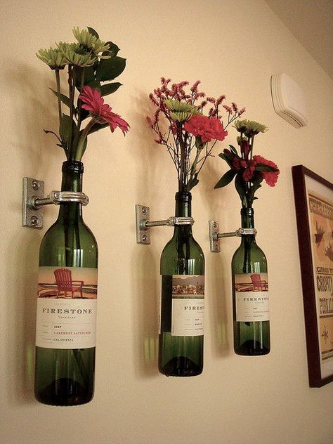 Wine bottles as flower vases! Would like this to decorate the wall in a kitchen. But maybe mount just one? Could also put on a bar cart, table, or any other counter space. Another idea is to get an empty Coke bottle or two, and put some colorful flowers in it; like daisies! Make sure the Coke bottle still has the red logo on it. Wine Bottles, The Wall, Wine, Flowers, Wall