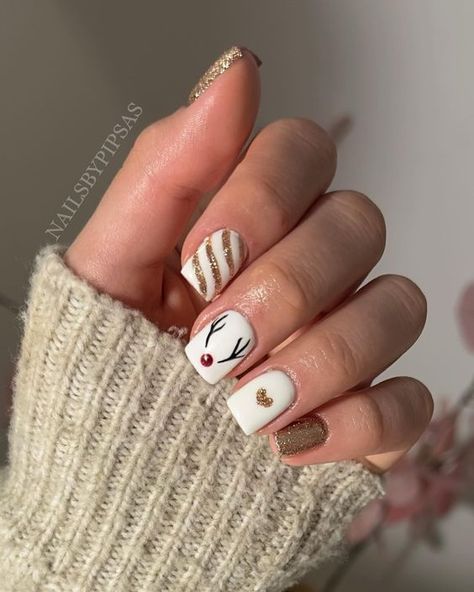 17 Festive Christmas Nail Designs for 2023 - thepinkgoose.com Reigndeer Nails, Reindeer On Nails, Christmas Nails Acrylic Reindeer, Christmas Nails Rain Deer Simple, Reindeer Nails Short, Reindeer Acrylic Nails, Christmas Nail Designs Reindeer, Rain Deer Nails, Christmas Shellac Nails Designs