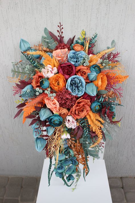 All the flowers and greenery is artificial and of high quality! Fall Western Bouquet, Rustic Wedding Bride Bouquet, Teal And Orange Flower Arrangements, Teal Burgundy Orange Wedding, Unique Fall Wedding Centerpieces, Flowers For October Wedding, Dark Teal And Burgundy Wedding Flowers, Wedding Flowers Blue And Orange, Teal And Rust Wedding Decor