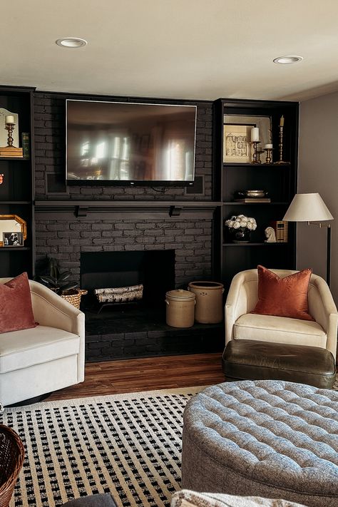 I am in love with our black brick fireplace accent wall and all of the cozy affordable furnishings we've put into this family room! The velvel swivel barrel chairs are so soft and comfortable and blend so well with our wool area rug and transitional, modern vintage home style! Black Fireplace Wall, Black Brick Fireplace, Brick Fireplace Wall, Fireplace Accent Walls, Fireplace Black, Black Brick Wall, Black Accent Walls, Black Fireplace, Brick Fireplace Makeover