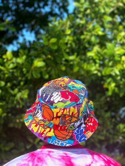 This one -of-a-kind bucket hat makes a great gift!  The Basketball Graffiti Bucket Hat represents a life well-lived. The visionary and artist in all of us. 20% of all gross proceeds are  invested in kids who have the drive to play and to help alleviate the financial burden associated with playing basketball and provide them with the resources they need on and off the court. -Comfortable and durable cotton twill construction. -One size fits most. -Premium dye will not bleed. Basketball Graffiti, Hip Hop Vintage, 90s Party, Playing Basketball, Life Well Lived, Donate To Charity, All Of Us, Hat Making, Pretty Cool