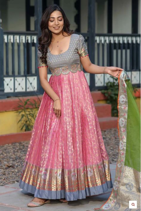 Kota Banarasi Silk Anarkali with Pethani Border and Maggam Worked Yoke Long gown for Festival occasion /partywear/ Wedding dress. Indulge in timeless elegance with this exquisite Zari Kota Banarasi Silk Anarkali. Crafted with intricate detailing and rich cultural heritage, this ensemble features a stunning Pethani border and meticulously hand-embellished Maggam work on the yoke. The puff sleeves add a touch of regal charm, while the delicate Net Dupatta drapes gracefully, completing the look. Wh Kota Anarkali Dress, Border Saree Dress Pattern, Banarasi Dress Pattern, Anarkali Dress With Saree, Traditional Gown From Saree, Kota Dresses Designs, Traditional Long Frocks Indian, Saree To Anarkali Dress Pattern, Silk Gown Designs Indian