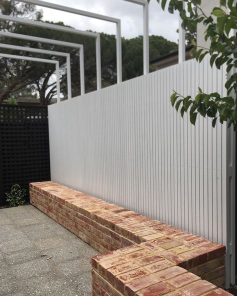 David Baptiste Garden Design on Instagram: “Recycled brick bench seat, slatted timber privacy screen and light steel pergola opens up the space in this courtyard garden - Burnside…” Brick Benches Diy Outdoor Seating, Brick Garden Design, Built In Garden Bench Seating, Brick Bench Seat, Brick Seating Outdoor, Brick Bench Outdoor, Timber Privacy Screen, Brick Seating, Brick Bench