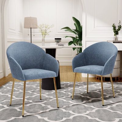 Designed with clean, sophisticated lines, this dining chair brings a contemporary flair to your interior. Its smooth silhouette and meticulous craftsmanship make it a practical seating option while also serving as a striking decorative element. Whether placed at a kitchen bar, home bar, or in a lounge area, this chair seamlessly enhances the overall aesthetic of your space. Crafted from high-quality materials with thoughtful design details, it ensures both durability and comfort, offering a smooth, immaculate texture for an enjoyable seating experience. Latitude Run® Upholstery Colour: Blue | Latitude Run® Set of 2 Contemporary Elegance Dining Chair blue, Metal | EODS6550_104371532 | Wayfair Canada Light Blue Dining Chairs, Blue Dining Chairs, Modern Kitchen Chair, Blue Dining Chair, Faux Leather Dining Chairs, Mid Century Dining Chairs, Dining Chairs Set, Blue Living Room, Velvet Dining Chairs