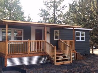 Take a look at this 1978 double wide remodel. Kelly and Frank were able to transform this older mobile home into a vacation getaway. Mobile Home Remodel Exterior, Double Wide Remodel, Single Wide Remodel, Mobile Home Remodel, Mobile Home Skirting, Home Remodeling Exterior, Eco Construction, Mobile Home Exteriors, Mobile Home Makeovers