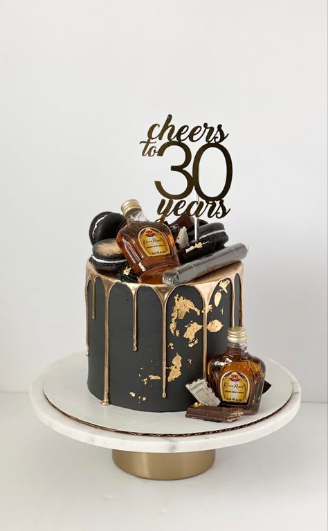 Black cake with gold drip and gold leaf details. On top and on the side there are assorted chocolates and crown royal bottles. There’s a cigar on top of the cake as well as a cake topper that reads “Cheers to 30 years”. Man 30th Birthday Ideas, 30th Birthday Party For Him, Cake Black And Gold, Dirty 30 Cake, 30th Birthday Cakes For Men, Black And Gold Birthday Cake, 35th Birthday Cakes, Cake For Him, Husband 30th Birthday