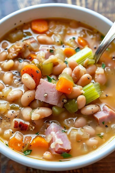 Stay warm this winter with a big bowl of old-fashioned ham and bean soup. It's a hearty, healthy, budget-friendly meal the whole family will love. Ham And Beans Soup Crockpot Recipes, Basic Ham And Bean Soup, Ham Potato Bean Soup, Classic Ham And Bean Soup, Crockpot Ham And Beans Soup, White Bean Ham Soup Crockpot, White Bean Ham Hock Soup, Southern Ham And Beans Crockpot Recipes, Han And Bean Soup