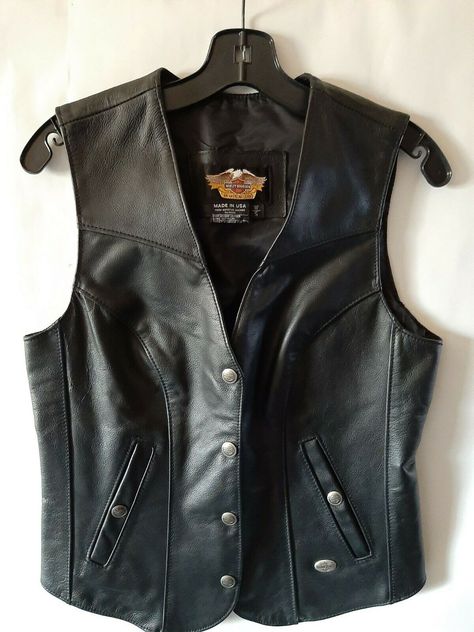 Harley Davidson Women's Black Leather Biker Vest  Snaps W/ Bar Shield Size Small MADE IN U.S.A. LEATHER OUTER AND NYLON LINING   IT IS IN GOOD CONDITION, HAS VERY LITTLE WEAR. COULD USE A LIGHT CLEANING. ZOOM IN ON THE  PICTURES TO SEE CONDITION. MEASURES APPROXIMATELY LAYING FLAT: 17 1/2" ARMPIT TO ARMPIT. 24" LONG FRONT X 21" LONG BACK WE WILL COMBINE SHIPPING TO SAVE YOU MONEY ON MULTIPLE PURCHASES OUR SHIPPING PRICES ARE FOR SHIPPING & HANDLING..WE ALWAYS ADD A TRACKI Biker Chick Outfit Halloween, Black Leather Vest Outfit, Motorcycle Style Women, Adult Goth Fashion, Leather Vest Outfits For Women, Biker Outfits For Women, Leather Vest Women, Leather Vest Outfit, Biker Chick Outfit