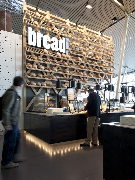 Travelers looking for last-minute gifts in Amsterdam's Schiphol airport need not venture far – a new space includes a cheese counter, bread shop, restaurant, plus flower store in one area.    Exuding a quintessentially Dutch vibe, the project is rooted in the culture and customs of the Netherlands, selling popular foods and products. Bread Display, Bakery Shop Design, Bakery Interior, Bread Shop, Retail Inspiration, Bakery Design, Bakery Shop, Retail Interior, Cafe Shop