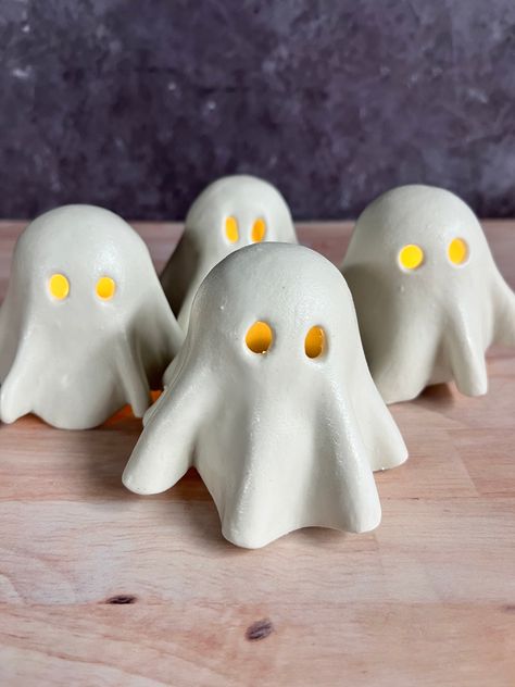 The perfect cute addition to your spooky season decor! These little ghosts are ready to grace your shelves and tables with the flickering light of a tea light candle. Order includes one ghost cover and tea light base. Tea light candles not included. Due to the handmade nature of this item, each ghost is one of a kind. The next round of ghosts is expected to ship by the end of August 2024. Ghost Tea Light Covers, Ghost Tea Lights, Clay Ghost Tealights, Fall Crafts Aesthetic, Natural Halloween Decor, Air Dry Clay Ghost, Clay Ghosts, Haloween Decor, Ghost Ceramic