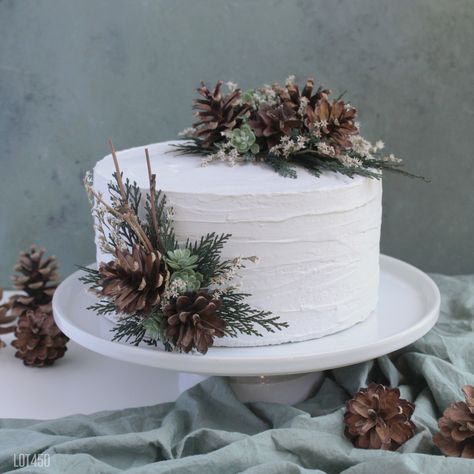 "2 piece pine cone cake decorating set. Made with preserved evergreen cedar, dried flowers, faux succulents and grapevine sticks. Kit includes 1 topper - 7\" x 4\" x 2\" 1  pick - 5\" tall x 4\" across The pick is made on a cream felt base with a 4\" wooden pick to insert into the cake. The topper is made on a wood base to easily add to the top of your cake. Want to purchase these separately? Topper: https://www.etsy.com/listing/1528931284 Pick: https://www.etsy.com/listing/1543149891 Loose flow Pinecone Cake Topper, Pine Cone Cake Topper, Winter Small Wedding Ideas, Winter Woodland Birthday Cake, One Tier Winter Wedding Cake, Pine Cone Wedding Cake, Pine Greenery Wedding, Winter Woodland Wedding Decor, Small Winter Wedding Cake