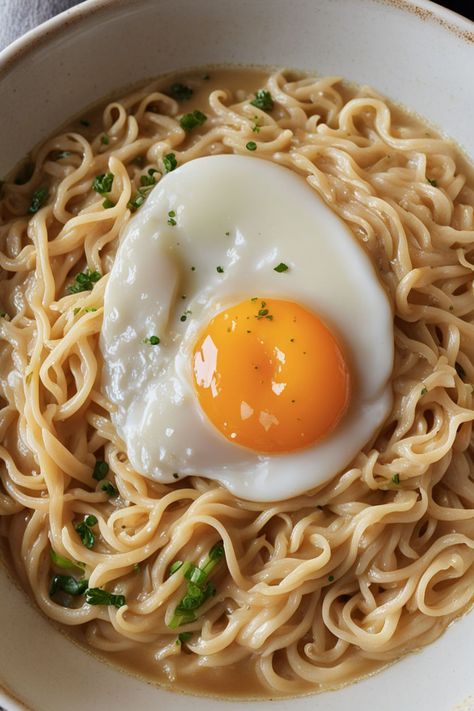 Creamy Ramen Noodles With Egg Recipe

Ingredients

- 2 packs of instant ramen noodles
- 2 cups water
- 1/2 cup heavy cream
- 2 large eggs
- 1 tablespoon soy sauce
- 1 green onion, chopped

Instructions

- In a pot, bring 2 cups of water to a boil and add the instant ramen noodles. Cook for 3-4 minutes until tender. 
- Stir in heavy cream and soy sauce, then create a small well in the noodles and crack the eggs into it. Cover and let cook for an additional 2-3 minutes. 
- Full Recipe on... Egg And Ramen Noodles, Easy Ramen With Egg, Roman Noodles With Egg, Ramen With Fried Egg, Ramen With Egg Recipes, Ramen Noodles With Shrimp, Creamy Ramen Noodles, Ramen Noodles With Egg, Ramen With Egg