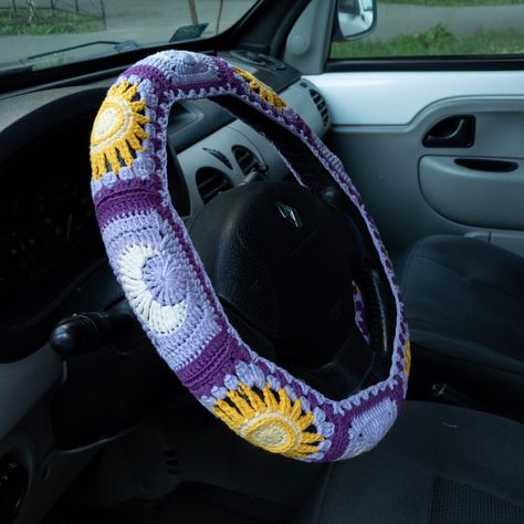 Crochet Sun Moon Steering Wheel Cover set with celestial car coasters and seat belt covers is hand crocheted in patchwork granny square style.  It's a great way to add aesthetic and boho &  hippie vibes  to your car decor interior. Also it would be a great cute gift for women, men, girls, teens or anyone who has a jeep or another car ;) You can buy only car stere wheel cover or make a set with other car accessories decorations:  - Matching car coaster set - https://www.etsy.com/shop/CherryCoob?r Purple Steering Wheel Cover, Car Interior Decor Diy, Whimsigoth Car Decor, Crochet For The Car, Crochet Car Seat Cover Pattern, Simple Car Decor, Purple Car Decor, Stuff To Put In Your Car, Whimsigoth Car