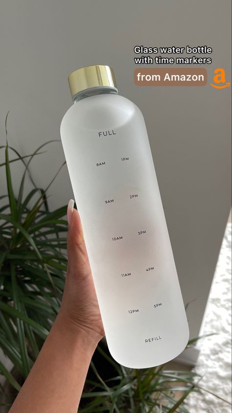 Frosted glass water bottle with time markers with a plant and a white wall in the background Trendy Water Bottles Amazon, Clear Water Bottle Amazon, That Girl Water Bottle, Shein Water Bottle, Glass Water Bottle With Straw, Clean Girl Water Bottle, Eco Friendly Water Bottle, Cute Water Bottles For School, Glass Water Bottle Aesthetic