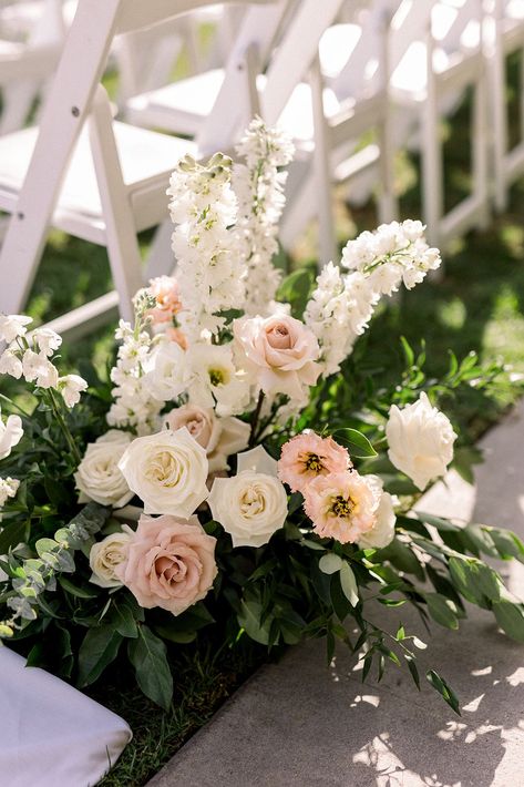 soft pink and white aisle floral arrangement #socalweddingplanner #timelessweddingcolors White Ground Floral Arrangement, White Ceremony Chairs, Pink And White Wedding Florals, Wedding Pergola Flowers, Floral Aisle Wedding, Wedding Aisle Flowers On Ground, Church Flowers Wedding, Light Pink And White Wedding, Flower Walkway