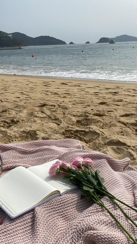 Pink blanket at the beach with a open journal a pink pen and pink flowers with long green stems overlooking the beach with a boat in the far distance - a mood Enjoy Life Aesthetic Pictures, Journaling At The Beach, Slow Living Aesthetic Summer, Conscious Living Aesthetic, Living The Life Aesthetic, Slow Lifestyle Aesthetic, Living On Your Own Aesthetic, Slowing Down Aesthetic, Mindful Living Aesthetic