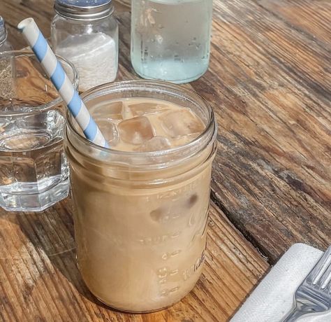 A cup of iced coffee with a stripped straw in it. Iced Coffee Mason Jar, Microinfluencer Aesthetic, Matilda Jr, Mason Jar Coffee, Coffee Mason Jar, Iced Coffee Aesthetic, Blue Banisters, Mason Jar With Straw, Order Coffee