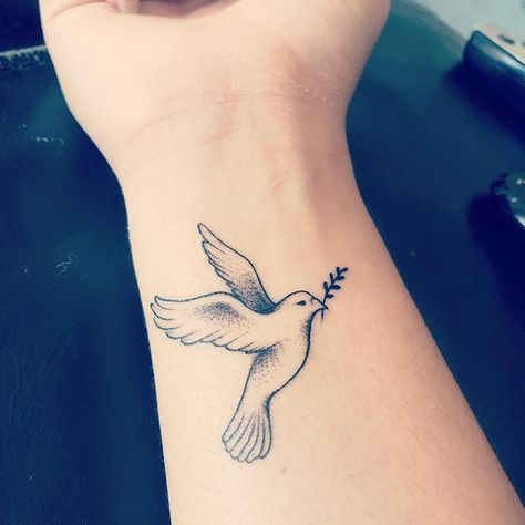 First tattoo! Dove holding an olive branch Which means the world to me as it represents peace and freedom. I have been through all sorts of… | Instagram Friendship Dove Tattoo, Dove Holding Olive Branch Tattoo, Christian Dove Tattoo, World Peace Tattoo, Dove Tattoo Traditional, Dove Olive Branch Tattoo, Dove And Olive Branch Tattoo, Traditional Dove Tattoo, Dove With Olive Branch Tattoo