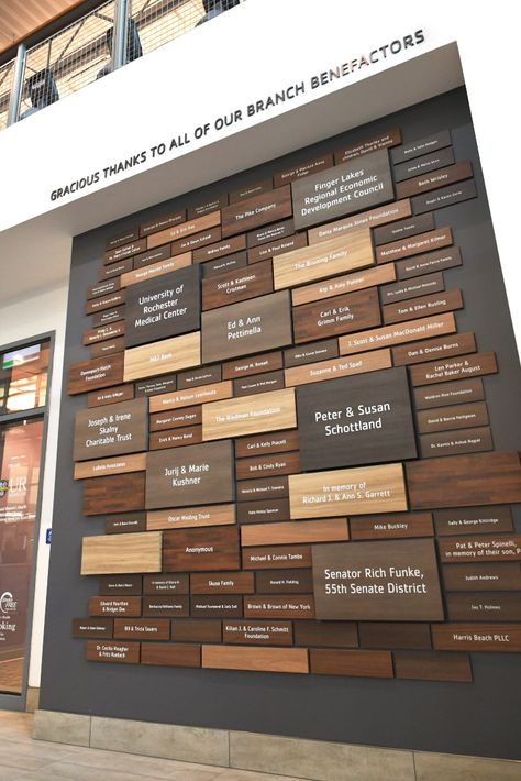 Custom donor recognition wall features woodgrain plaques of various sizes for community center. Donor Tree, Donor Wall Design, Donor Plaques, Donor Recognition Wall, Environmental Branding, Food Logo Design Inspiration, Donor Recognition, Donor Wall, Capital Campaign