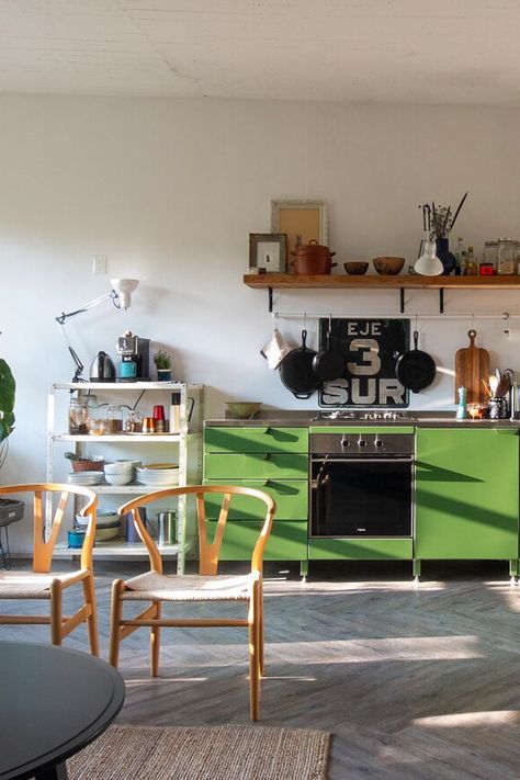 Since the apartment came with a large living room, Libia and Enrique transformed it into an all-in-one living space. Their powder-coated steel cabinets with stainless steel counter are by Rallé, a new Mexico City company specializing in modular metal kitchen designs. Libia and Enrique decided they wanted steel cabinets after visiting a Mexico City building where the kitchens were “the originals from the sixties, all metal and funky colors.” Colourful Kitchen, Urban Kitchen, Big Room, Stainless Steel Counters, Colorful Kitchen, Steel Cabinet, Metal Kitchen, Living Room Windows, Old Kitchen