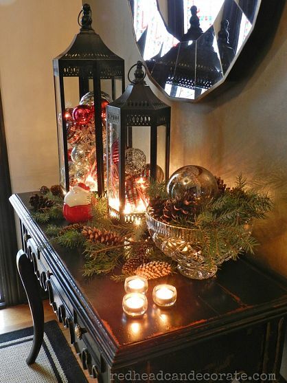 Put ornaments in glass lanterns and fill bowls with pine cones and pine needles to create a fabulous Christmas vignette. Lanterns, Side Table, Christmas Decorations, Candles, Christmas