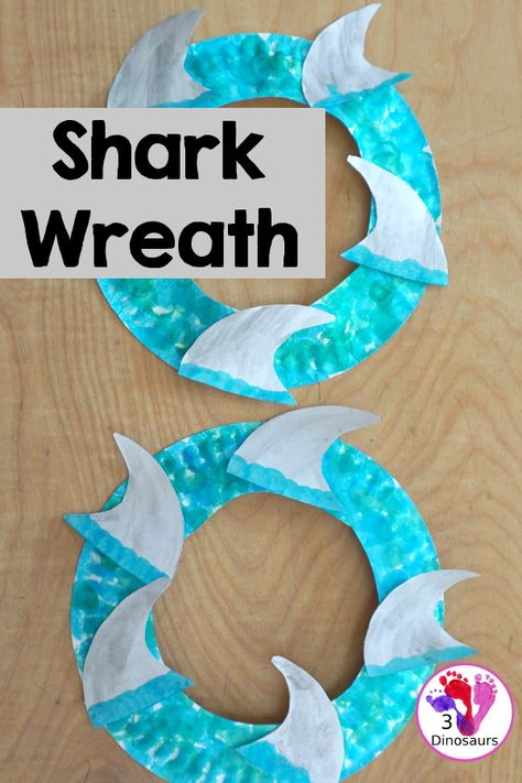 Shark Fin Wreath Craft for Shark Week | 3 Dinosaurs Toddler Shark Craft, Shark Week For Toddlers, Shark Week Art Projects For Kids, Shark Craft For Preschool, Easy Shark Craft, Shark Week Crafts For Toddlers, Shark Art Project, Shark Art For Toddlers, Shark Art Preschool