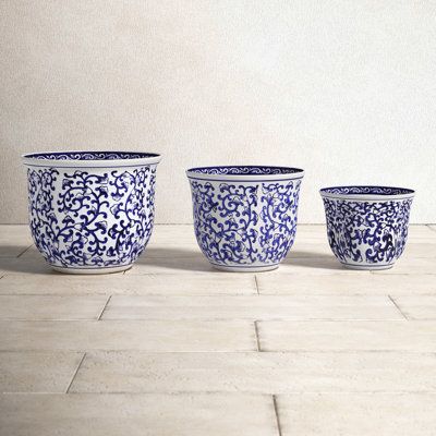 The meandering vine pattern of these inverted bell-shaped planters is reminiscent of the tapestries of the florentine renaissance. The blue-on-white design is a perennial favorite of decorating and looks chic in a wide variety of settings. The useful shape and sizes are the ideal home for your indoor plants. | Birch Lane™ Cypress Blue & White Handmade Ceramic Outdoor Garden Planter Set of 3 Ceramic | 9 H x 12 W x 10 D in | Wayfair Blue And White Chinoiserie Pots & Planters, Bedroom Pics, Outdoor Garden Planters, White Ceramic Planter, Railing Planters, Vine Pattern, Urn Planters, Window Planter Boxes, White Planters