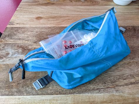 Supplements in a blue bag illustrate how to pack vitamins and supplements for travel. Minimalist Packing, Altitude Sickness, Packing Essentials, Vitamins And Supplements, Travel Container, Ways To Travel, Medical Prescription, One Bag, Travel Light