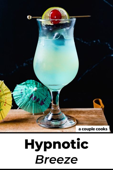 This Hpnotiq drink, the Hypnotic Breeze, stars the fruity blue liqueur with tropical flavors like pineapple and lime. It's a stunner! #hpnotiq #hypnotic #hypnoticdrink #hpnotiqdrink #hypnoticbreeze #beachdrink Hypnotic Drinks, Hpnotiq Drinks, Girls Night Drinks, Alcohol Spirits, Coconut Drinks, Blue Drinks, Yummy Alcoholic Drinks, Happy Hour Drinks, Fruity Drinks