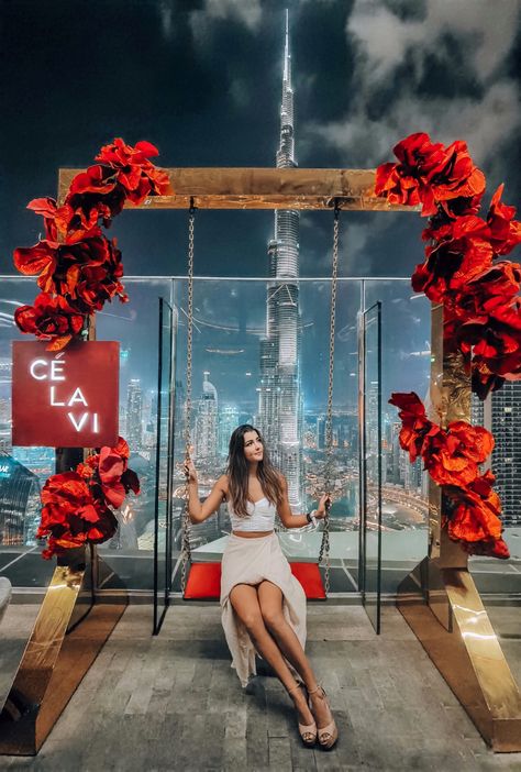 Stunning Night View of Dubai Skyline, rooftop view of the Burj Khalifa, with Girl (Emily) in the centre on a swing covered in Roses Dubai, Red, Travel, Instagram