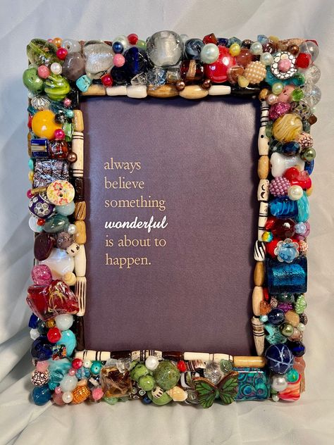 "This gorgeous hand beaded photo frame will fit your favorite 5\"x 7\" photo. Each bead is thoughtfully placed by hand, then all is sealed in a waterproof, pearly glaze. Clean with a damp cloth. Edged in ribbon, with an easel back for tabletop use , and hooks for hanging. Total frame is 8\" x 6-1/2\"  I use an eclectic mix of beads in all my work, including Czech glass, Swarovski crystals, resin, acrylic, faux pearls, mixed metal, semi-precious stones, polished stones, polished glass, Murano gla Old Jewelry Crafts, Bead Frame, Resin Acrylic, Diy Picture Frames, Craft Day, Repurposed Jewelry, Mosaic Projects, Frame Crafts, Button Crafts